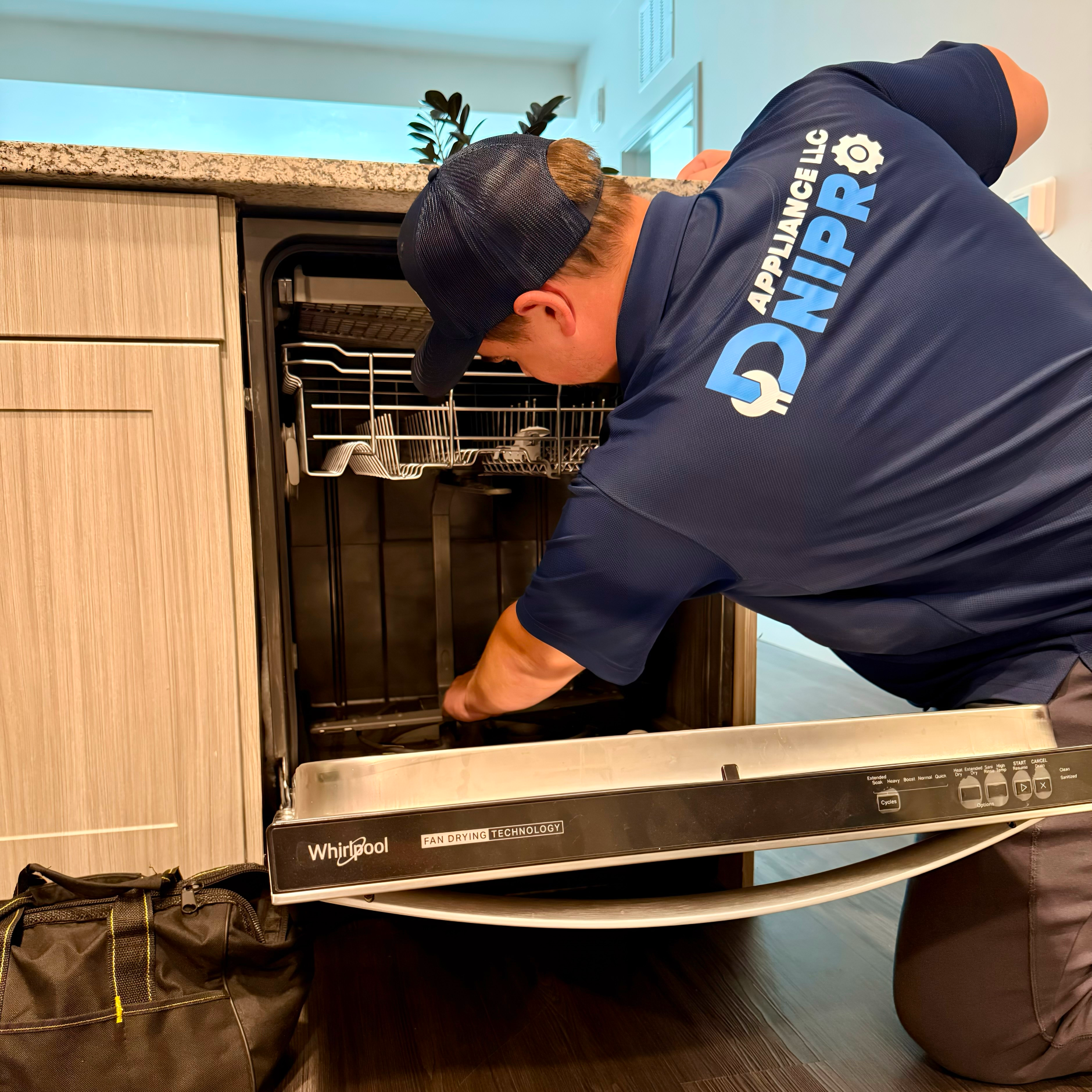 repairman-near-dishwasher-kitchen_